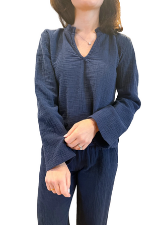 Person wearing a blue textured outfit with a blurred background
